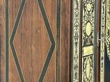 a large wooden cabinet with a black and gold design