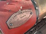 a close up of a red motorcycle with a metal handlebar