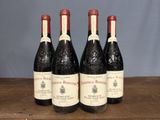 four bottles of wine are lined up on a wooden table