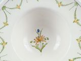 a white bowl with a yellow flower on it