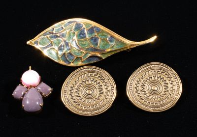 two pieces of jewelry sitting next to each other on a black surface