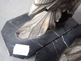 a statue of a bird that is sitting on a table
