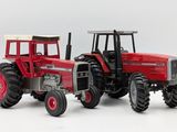 a red tractor that is sitting on a white surface