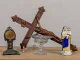 a statue of jesus on the cross and other religious items on a table