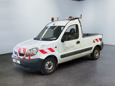 a white truck with red and white stripes parked in a room