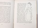 an open book with a drawing of a woman holding a baby