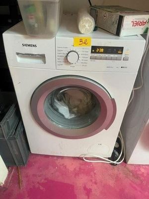 a washing machine that is sitting on top of a counter