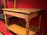 a wooden table with a shelf on top of it