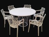 a white table with four chairs around it on a black background