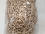 a bag of rubber bands on a white surface