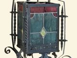 a metal wall mounted mailbox with a stained glass window