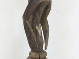 an image of a wooden statue of a man with a hat on it ' s head