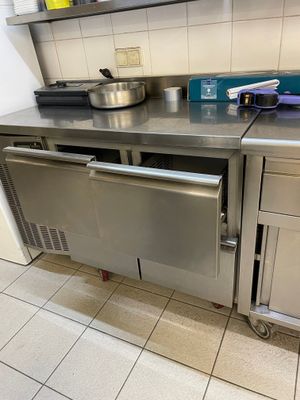 a stainless steel counter with a dishwasher on it