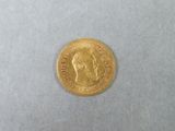une pièce d'or sur laquelle figure l'image d'un homme