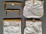 three white purses with gold trims and chains on them