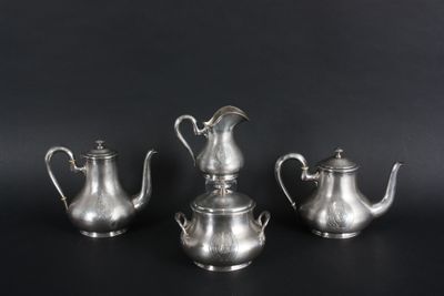 three silver teapots and a coffee pot on a black background