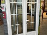 a white double door with a glass pane in a store