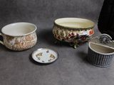 three cups and a bowl sitting on a table