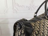 an image of a large black and tan bag with a black handle