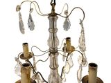a chandelier that has a candle holder on it