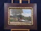 an oil painting of a bridge over a river on a wooden easel