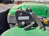 a close up of a green tractor with a couple of screws on it
