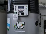 a water heater that is on the side of the wall