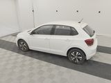 a white car is parked in a garage with a checkered floor
