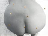 a picture of a woman ' s butt with gold studs on it