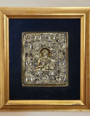 an ornate gold plate with a picture of a man and a woman