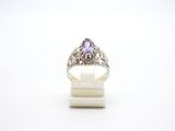 a close up of a ring with a purple stone in it