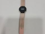 a close up of a smart watch sitting on a white surface