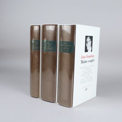 three books are stacked on top of each other on a table