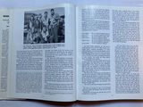 an open book with a picture of a group of men