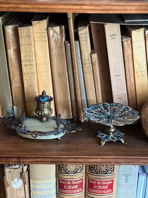 de nombreux livres sur une étagère surmontée d'une horloge