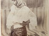 an old photo of a woman wearing a headdress