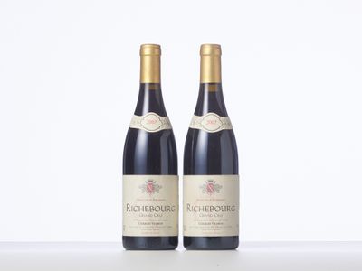 two bottles of wine sitting on top of a table