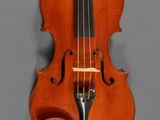 an antique violin with a wooden case and bow on a gray background