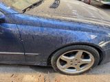 a blue car that is parked on the side of the street