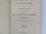 an old book opened to show the title of a history of england