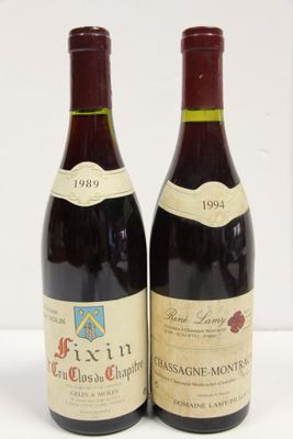 two bottles of red wine sitting next to each other on a table