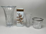 three vases and a cup sitting on a table