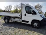 a white truck that is parked in the gravel