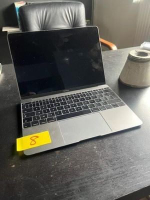 a laptop computer sitting on a desk with a cup of coffee