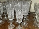 a lot of wine glasses sitting on a wooden table
