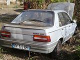 a car that is sitting in the grass with its hood up