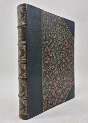 a black book with gold trim and a green cover