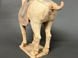 an old statue of a horse with a saddle on it ' s back