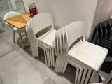 four chairs and a table in the corner of a room