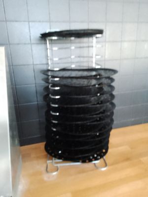 a stack of black plates on a metal stand